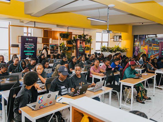 A full room of students working on laptops at a workshop