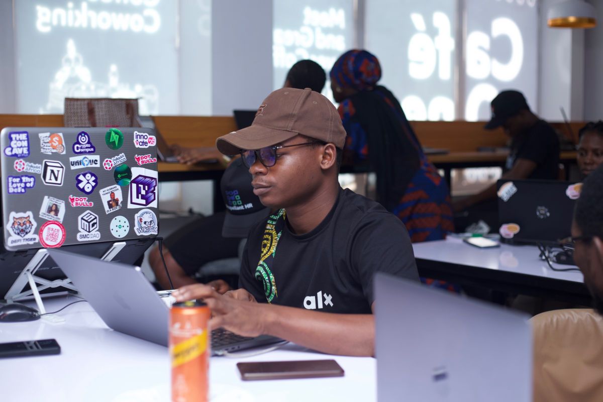 A participant working on a laptop at a coworking event